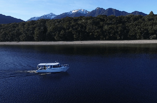 Boat travelling across Lake Manapouri